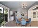 Bright dining area with modern light fixture, stylish decor, and sliding glass doors to the backyard at 7596 N Via De La Siesta --, Scottsdale, AZ 85258