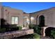 Inviting entrance with beautiful stonework, an iron gate, and lush landscaping, creating a warm and welcoming atmosphere at 7596 N Via De La Siesta --, Scottsdale, AZ 85258