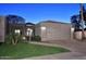 Charming single-story home featuring a well-manicured lawn, two-car garage, and inviting exterior lighting at 7596 N Via De La Siesta --, Scottsdale, AZ 85258