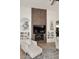 Stylish fireplace with a herringbone-patterned feature wall, built-in shelves, and modern decor at 7596 N Via De La Siesta --, Scottsdale, AZ 85258