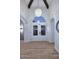 Bright foyer featuring wood-look flooring, an arched transom window, and a modern lighting fixture at 7596 N Via De La Siesta --, Scottsdale, AZ 85258