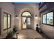 Inviting front entrance showcasing an arched doorway, elegant lighting, and stylish doors at 7596 N Via De La Siesta --, Scottsdale, AZ 85258