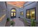 The charming front entrance showcases a paved walkway, elegant landscaping, and a welcoming double-door entry at 7596 N Via De La Siesta --, Scottsdale, AZ 85258