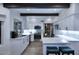 Modern kitchen boasts white cabinets, stainless steel appliances, a breakfast bar, and abundant natural light at 7596 N Via De La Siesta --, Scottsdale, AZ 85258