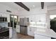 Updated kitchen featuring stainless steel refrigerator, white cabinets and light countertops at 7596 N Via De La Siesta --, Scottsdale, AZ 85258