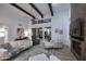 Stylish living room with beamed ceilings, a herringbone fireplace, and a large sliding door to the backyard at 7596 N Via De La Siesta --, Scottsdale, AZ 85258