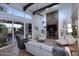Spacious living room with a fireplace, custom ceiling beams, and a sliding door to the patio at 7596 N Via De La Siesta --, Scottsdale, AZ 85258