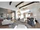 Bright living room with exposed beams offering a view of the dining area, fireplace, and exterior at 7596 N Via De La Siesta --, Scottsdale, AZ 85258