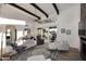 Spacious living room with high ceilings, exposed beams, a ceiling fan, and large sliding glass doors to the patio at 7596 N Via De La Siesta --, Scottsdale, AZ 85258