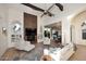 Open-concept living room showcasing a modern fireplace, exposed beams, and seamless flow to the dining area at 7596 N Via De La Siesta --, Scottsdale, AZ 85258