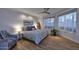 Serene main bedroom with wood floors, neutral tones, large windows, and stylish ceiling fan at 7596 N Via De La Siesta --, Scottsdale, AZ 85258