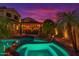 Enjoy this backyard pool with a built-in bar, lush landscaping, and vibrant sunset views, creating an idyllic outdoor retreat at 838 E Nolan Pl, Chandler, AZ 85249