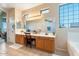 Well-lit bathroom featuring double sinks, large mirrors, and a separate tub for convenience at 838 E Nolan Pl, Chandler, AZ 85249