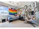 Eclectic bedroom with unique hanging chair, personal decor, and comfortable bed, creating a cozy retreat at 838 E Nolan Pl, Chandler, AZ 85249