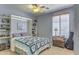 Comfortable bedroom with built-in shelving, stylish bedding, and ample natural light from the window at 838 E Nolan Pl, Chandler, AZ 85249