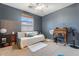 Bedroom featuring a daybed, ceiling fan, and classic wooden desk with chair, perfect for study or relaxation at 838 E Nolan Pl, Chandler, AZ 85249