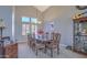Elegant dining room with large table, high ceilings and ample natural light from multiple windows at 838 E Nolan Pl, Chandler, AZ 85249