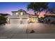 Charming two-story home with a desert landscape and a three-car garage, set against a colorful sunset sky at 838 E Nolan Pl, Chandler, AZ 85249