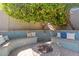 Backyard fire pit with built in bench seating and lush landscaping at 838 E Nolan Pl, Chandler, AZ 85249