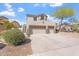 Beautifully landscaped front yard with desert plants and a two-story home with a three-car garage at 838 E Nolan Pl, Chandler, AZ 85249
