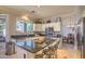 Bright and open kitchen featuring stainless steel appliances, island seating, and backyard views at 838 E Nolan Pl, Chandler, AZ 85249