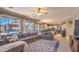 Open living room with large windows, a comfortable sectional sofa, and access to the backyard pool at 838 E Nolan Pl, Chandler, AZ 85249