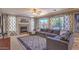 Cozy living room with a fireplace, large windows overlooking the backyard, and comfortable seating at 838 E Nolan Pl, Chandler, AZ 85249