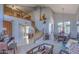 Open-concept living space with high ceilings, a staircase, and adjacent dining area for entertaining at 838 E Nolan Pl, Chandler, AZ 85249