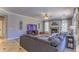 Relaxing living room with a fireplace, large sectional sofa, ceiling fan, and neutral tones at 838 E Nolan Pl, Chandler, AZ 85249
