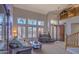 Bright living room with large windows, plantation shutters, high ceilings, and a comfortable seating area at 838 E Nolan Pl, Chandler, AZ 85249