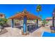 Outdoor bar area with seating, a custom roof, and a lush backyard, ideal for entertaining and relaxation at 838 E Nolan Pl, Chandler, AZ 85249