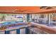 An outdoor bar with grill and sink overlooks the sparkling backyard pool at 838 E Nolan Pl, Chandler, AZ 85249