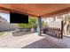 Inviting covered patio with swing, tv and landscaped backyard at 838 E Nolan Pl, Chandler, AZ 85249