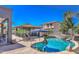 Inviting pool with rock waterfall, covered bar, lounge chairs, and lush landscaping at 838 E Nolan Pl, Chandler, AZ 85249