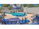 Sparkling pool with water feature, lounge chairs, umbrellas, and lush desert landscaping at 838 E Nolan Pl, Chandler, AZ 85249
