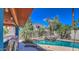 Gorgeous pool with rock waterfall feature, mature landscaping, and covered bar area for entertaining at 838 E Nolan Pl, Chandler, AZ 85249