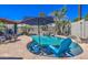 Inviting pool with umbrellas and mature landscaping, perfect for outdoor enjoyment and relaxation at 838 E Nolan Pl, Chandler, AZ 85249