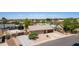 Aerial view of a well-maintained home with a spacious yard, lush landscaping, and a long driveway at 846 N 81St St, Mesa, AZ 85207