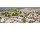 Aerial view of a residential area featuring numerous homes, lush green spaces, and a community park at 846 N 81St St, Mesa, AZ 85207