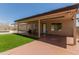 A covered back patio with seating and lush green turf, perfect for outdoor relaxation and entertainment at 846 N 81St St, Mesa, AZ 85207