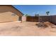 Backyard with a wood fence, dirt piles, and a gate for access to another area at 846 N 81St St, Mesa, AZ 85207