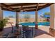 A lovely outdoor patio with seating overlooking a private pool and lush landscaping is great for entertaining at 846 N 81St St, Mesa, AZ 85207