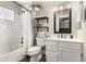 Cozy bathroom featuring a shower/tub, shelving, and a decorative mirror and light fixture at 846 N 81St St, Mesa, AZ 85207