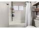 Bathroom with white subway tile, frosted window and black shelving at 846 N 81St St, Mesa, AZ 85207