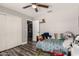 Bedroom features a bed, ceiling fan, and an adjacent laundry area at 846 N 81St St, Mesa, AZ 85207