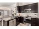 Contemporary kitchen featuring stainless steel appliances and dark countertops and cabinets at 846 N 81St St, Mesa, AZ 85207