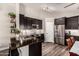 Stylish kitchen boasts sleek countertops, stainless steel appliances, and dark wood cabinets at 846 N 81St St, Mesa, AZ 85207