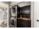Modern laundry room featuring stacked washer and dryer, and custom cabinets at 846 N 81St St, Mesa, AZ 85207