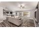 Open-concept living room features a ceiling fan, wood flooring, and an opening to the kitchen at 846 N 81St St, Mesa, AZ 85207