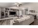Spacious living room with a built-in entertainment center, a ceiling fan, and a neutral color scheme at 846 N 81St St, Mesa, AZ 85207